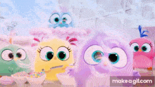 a group of angry birds are standing next to each other .