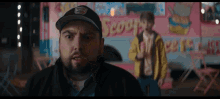 a man standing in front of an ice cream truck that says scoops on it