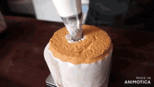 a chiffon cake is being decorated with icing and the words made in animotica are visible