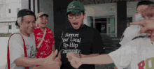 a man wearing a support your local hip-hop community shirt