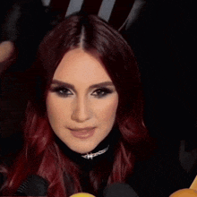 a woman with red hair is making a funny face and says i qué