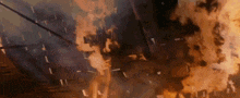a building is on fire and smoke is coming out of the ceiling .