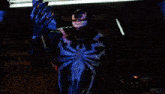 a computer generated image of venom holding a red sphere in his hand
