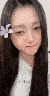 a girl with a flower in her hair is wearing a t-shirt that says " toi " on it