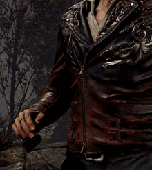a man wearing a brown leather jacket holds a cigarette