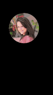 a close up of a woman 's face in a circle with a black background