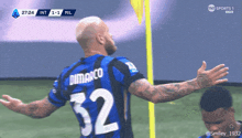a soccer player with the number 32 on his jersey is celebrating
