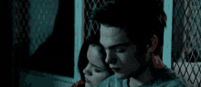 a man and a woman are sitting next to each other in the dark .