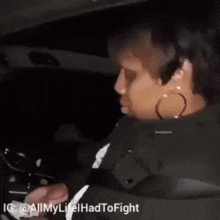 a woman is sitting in a car with a caption that says " all life had to fight "
