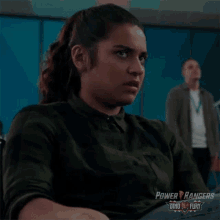 a woman is sitting in front of a man in a power rangers dino fury advertisement .