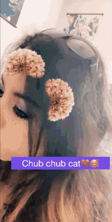 a girl with flowers in her hair has chub chub cat written on the bottom