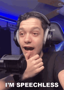 a man wearing headphones and a watch says i 'm speechless