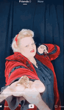 a woman in a red coat is holding a gold object in her hand with the words friends now below her