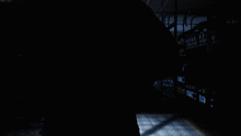 a dark room with a sign that says exit on the wall