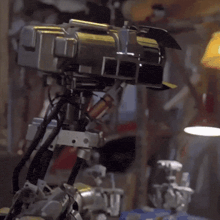 a close up of a robot 's eyes with a yellow antenna