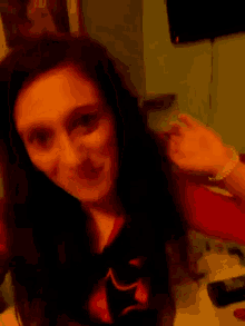 a girl sticking out her tongue and wearing a shirt that says ' x ' on it