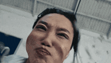 a close up of a woman making a face with her mouth open