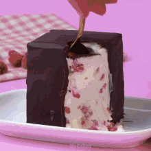 a white plate with a piece of cake on it that says mr cakes on it