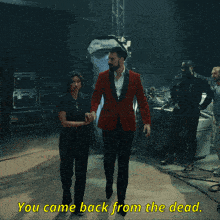 a man in a red suit says sums up my career while dancing