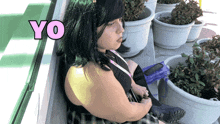 a woman in a green wig sits in front of potted plants and the word yo is above her