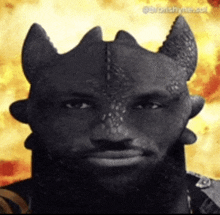 a man with a beard is dressed as a dragon with horns