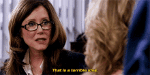 a woman with glasses is talking to another woman and says that is a terrible idea