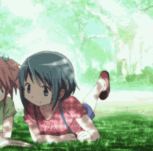 two anime girls are laying in the grass looking at something