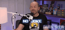 a man wearing a black shirt that says no joke dark web