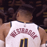a basketball player with the name westbrook on the back of his shirt