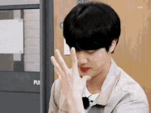 a young man making a peace sign with his hands