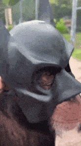 a close up of a batman mask on a person 's face