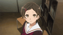 a girl in a school uniform with a red ribbon in her hair looks at the camera
