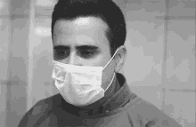 a man wearing a surgical mask and a gown