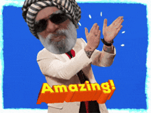a man with a beard wearing a turban and sunglasses is applauding with the words amazing behind him