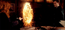 a man and a woman are standing next to each other with fire coming out of their faces