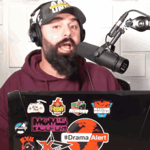 a man with a beard is wearing headphones and a hat that says on air