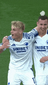 two soccer players one of whom is wearing a unibet jersey