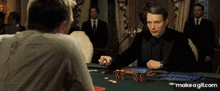 a man in a tuxedo is playing a game of poker with another man