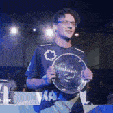 a man holding a trophy that says ' a ' on it