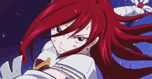 a girl with long red hair is holding a sword in her hand