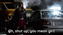 a woman in a superman costume says " oh shut up you mean girl " in front of cars