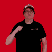 a man wearing glasses and a hat that says raptors