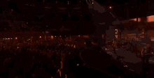 a group of people are playing instruments on a stage in a dark room .