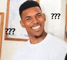 a man with a beard is smiling and making a funny face with a question mark .