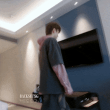 a man standing in a room with the word baeksung on the bottom right