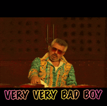 a man wearing sunglasses and a colorful shirt says " very very bad boy "