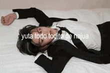 a man in a suit and tie is laying down on a bed
