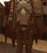 a puppet in a suit and bow tie is standing in a living room