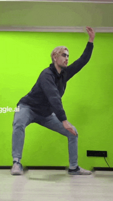 a man is dancing in front of a green wall with the word giggle.ai on the bottom right