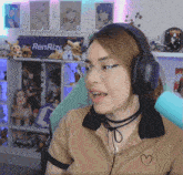 a woman wearing headphones is sitting in front of a renrize sign